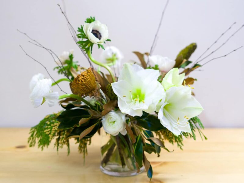 Holiday Glow flower arrangement featuring amaryllis, anemones, and ranunculus.