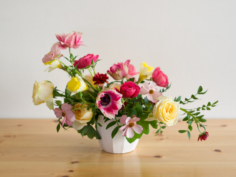 "Sweethearts" flower arrangement featuring anemones, ranunculus, roses, and daffodils.